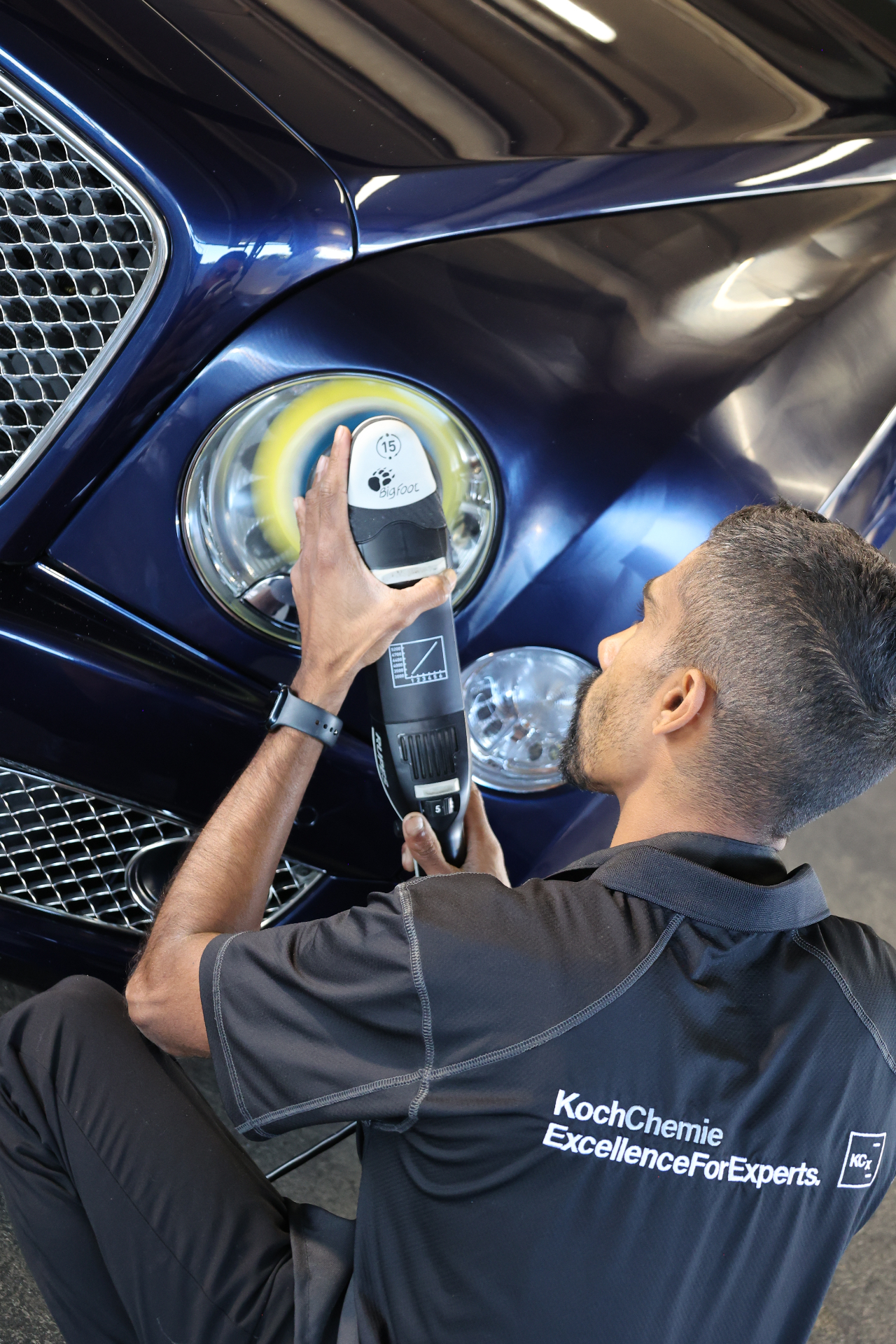 Koch-Chemie certified detailer polishing a Bentley headlight